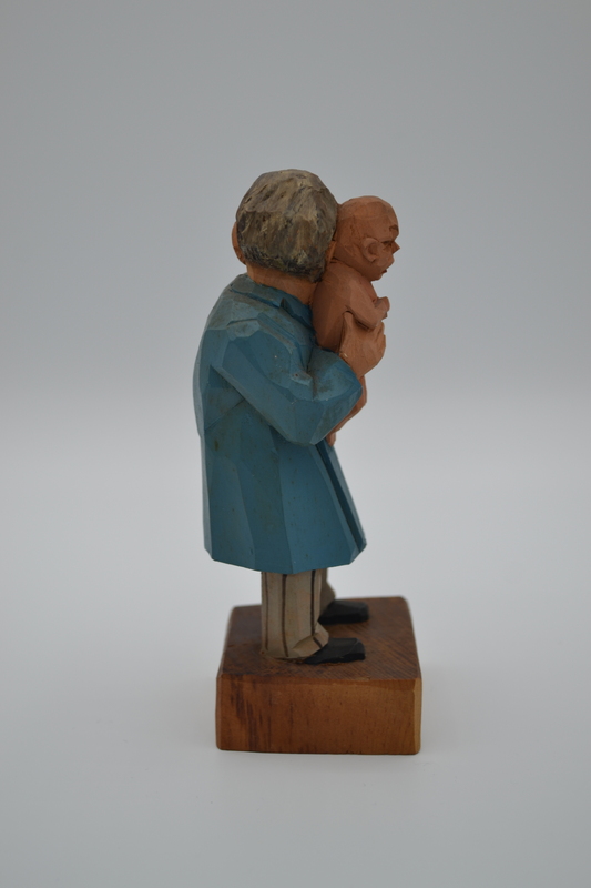 A wood figurine of pediatrician with inscription: "Constipation? - Rhubarb!" in German