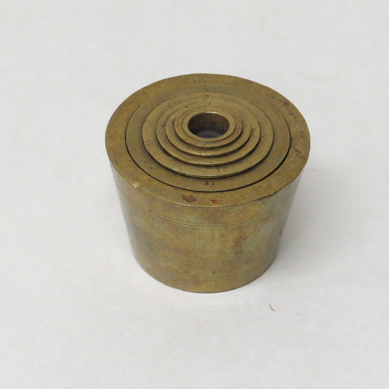 Brass nested weight set for assaying. 5 weights from 1.0 to 16.0. Stamped I T in center of 1.0 weight. Copper plated copper decorative mining pan, 9" diameter.