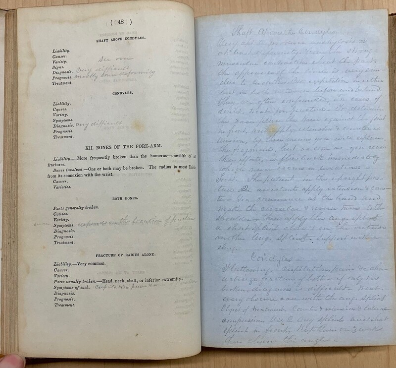 Open book with text on the left page and handwritten notes on the right page.