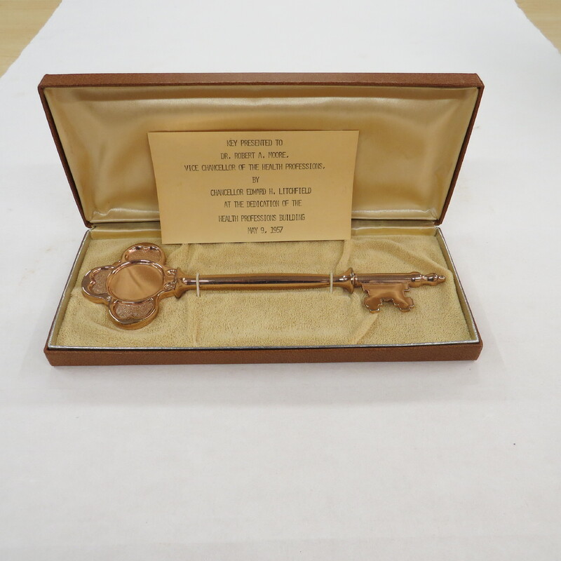 Commemorative Key presented to Dr. Robert A. Moore,  Vice Chancellor of the Health Professions, by Chancellor Edward H. Litchfield at the dedication of the Health Professions Building.