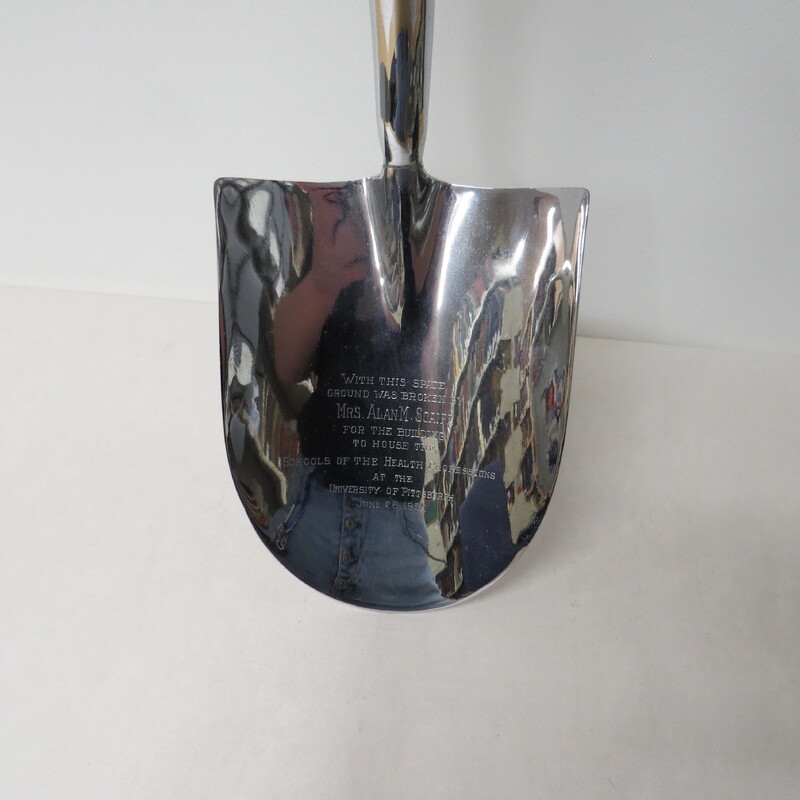 A close up of the inscription  on the spade used to break ground for the building of School of the Health Professions at the University of Pittsburgh.
