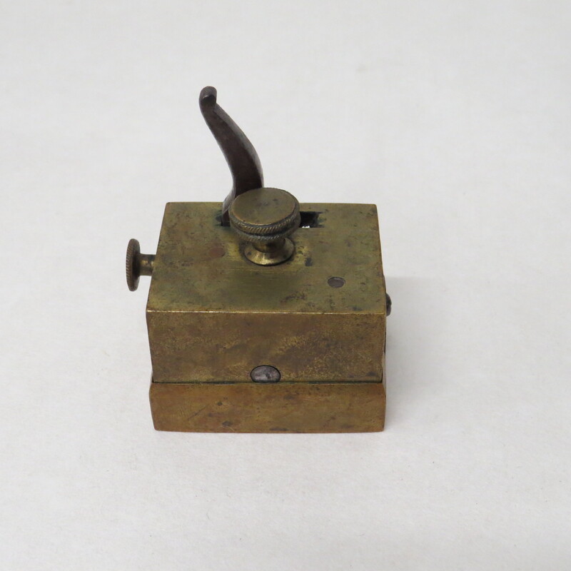 Sixteen-bladed square brass scarificator, blades arranged on three rods, cutting in the same direction. 