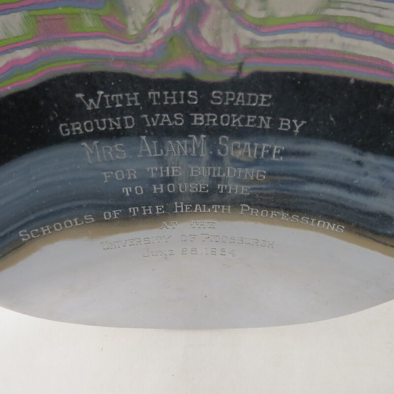 A close up of the spade used to break ground for the building of School of the Health Professions at the University of Pittsburgh.