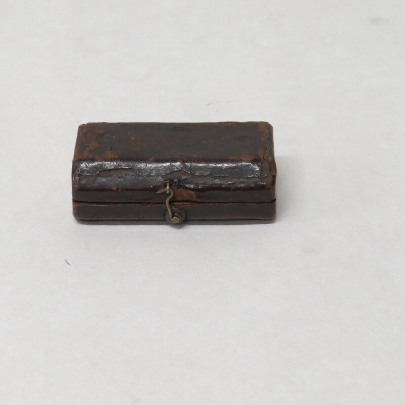 Brass spring lancet in typical case made of wood covered in leather and lined with chamois