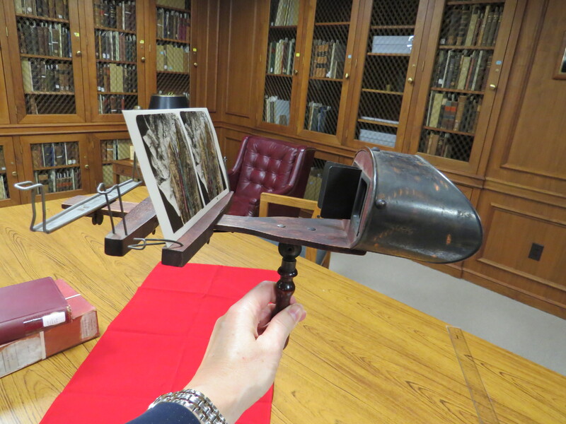 An antique viewer for stereoscopic images with 3 card holders.