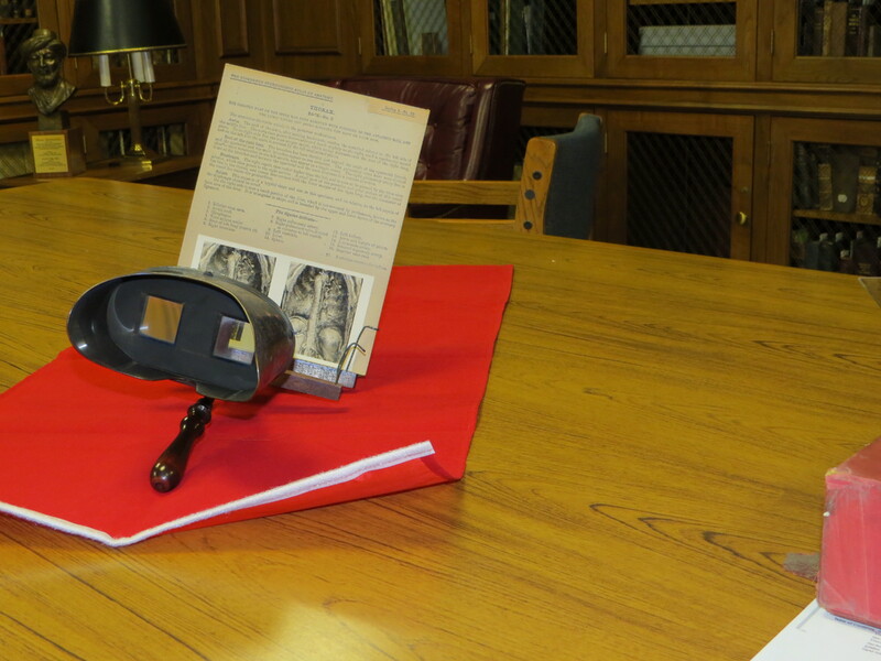 An antique viewer for stereoscopic images with 3 card holders.