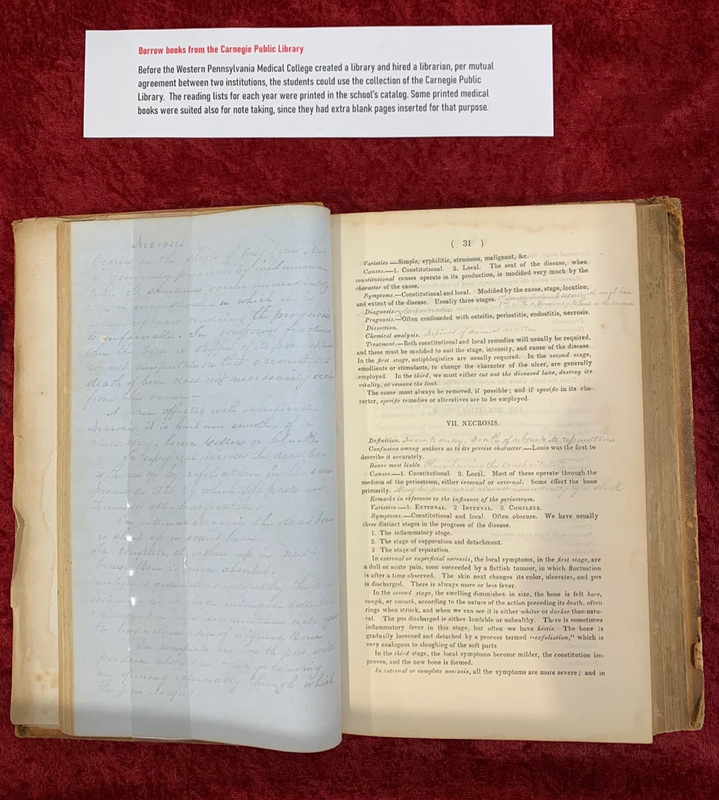 Open book. Handwritten sheet of notes is shown on the left page. The right page shows text from a textbook, with handwritten annotations on the page.