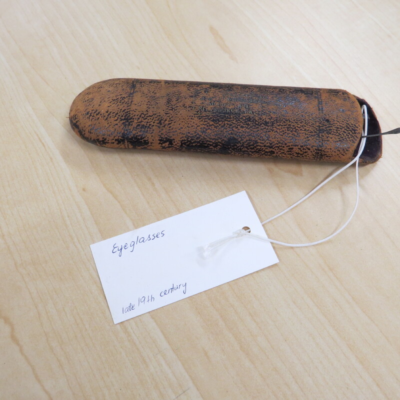 eyeglasses case with identifying tag that reads "eyeglasses, late 19th century"