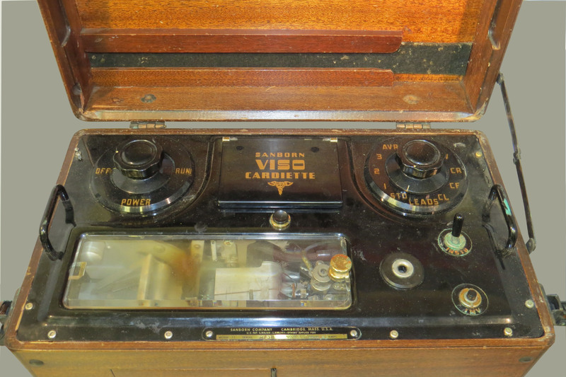 A wooden case with a handle and a brass plaque inscribed: "Dr. W.J.Armstrong." Case contains portable electrocardiograph (model 51, serial 9758).