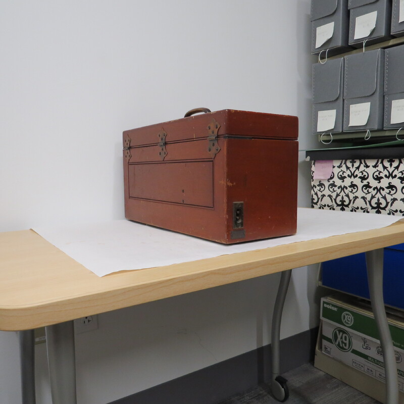 A wooden case with a handle and a brass plaque inscribed: "Made for Bernard Fuchs MD." Case contains portable electrocardiograph. Unlike earlier battery powered photographic models, this is an AC powered instrument.