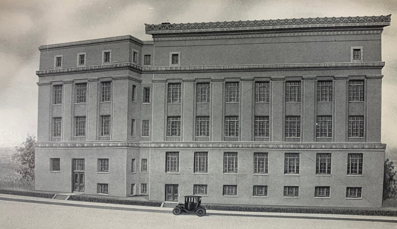 Black and white photograph of a large five-story stone building with a Model T style car in front of it.