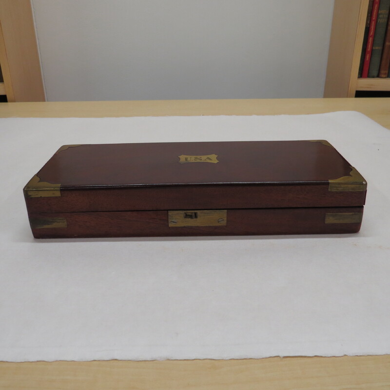 A post mortem surgical wooden tool box with USA labeled on it.