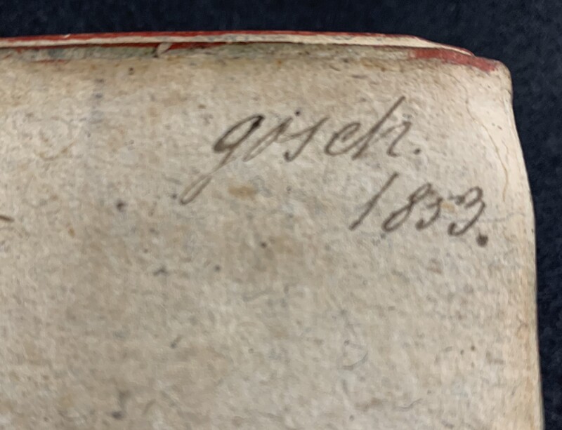 A photo of a page in an old book showing a handwritten note that reads "gosch 1853."