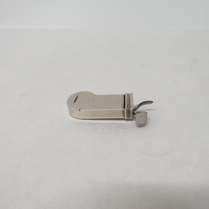 A white metal spring lancet with a button trigger