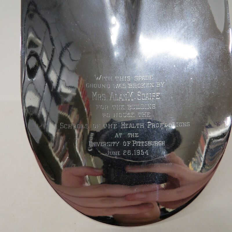 A close up of the spade used to break ground for the building of School of the Health Professions at the University of Pittsburgh.