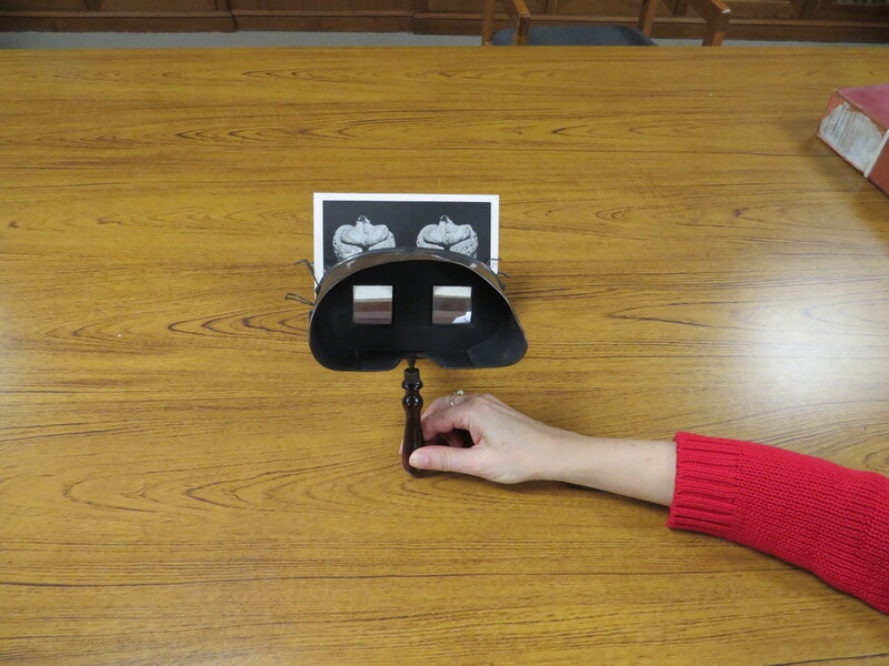 An antique viewer for stereoscopic images with 3 card holders.