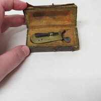 Brass spring lancet with steel lever release in typical case made of wood covered in leather and lined with chamois.